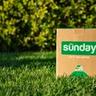 A box of Sunday lawn care products placed in the grass