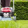 A homeowner mowing a lawn