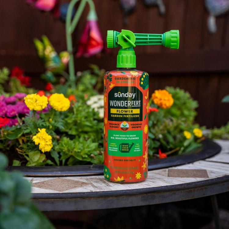 Image of WonderFert Flower Fertilizer next to a flower planter