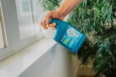 Person applying Bug Doom RTU Spray inside of home.