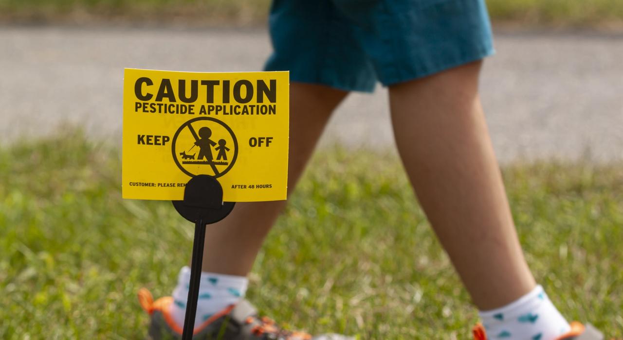Pesticide application sign in lawn