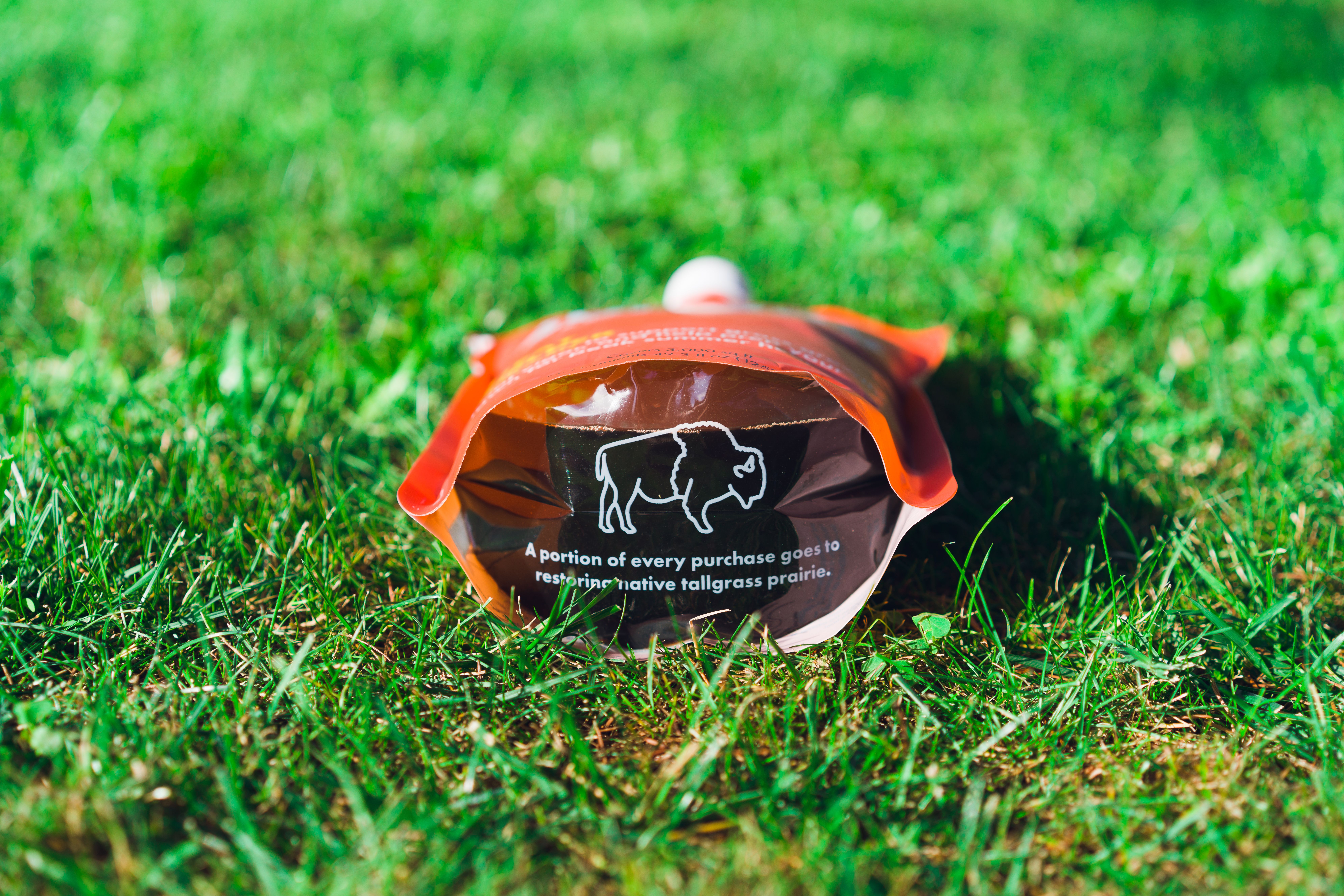 Sunday lawn fertilizer pouch on green grass