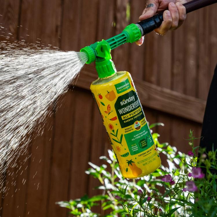 WonderFert All Purpose Garden Fertilizer on hose, spraying close up