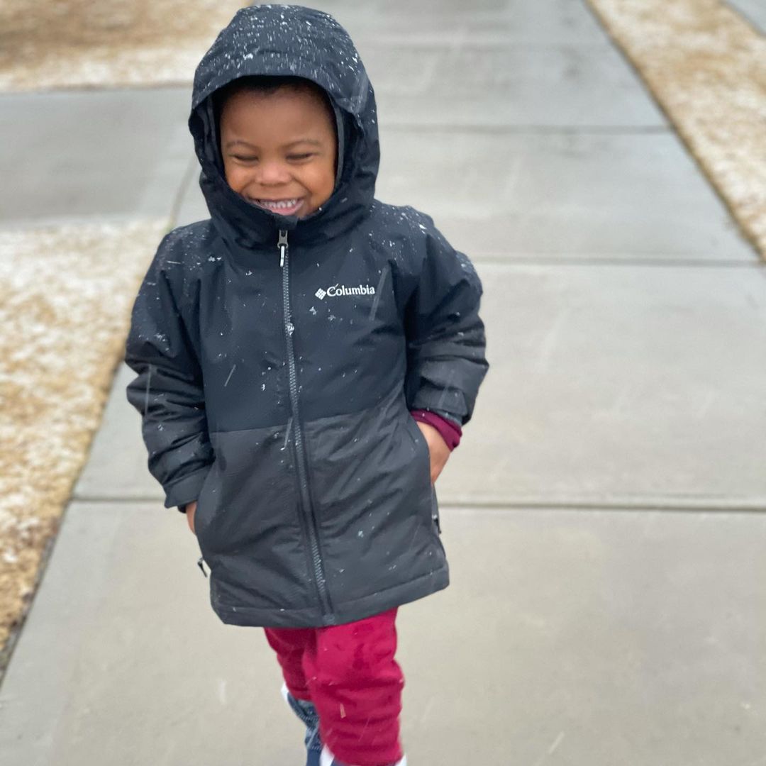 A smiling little boy enjoying the yard