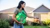 Woman spreading seed on lawn
