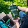 Woman unboxing a Sunday custom lawn plan