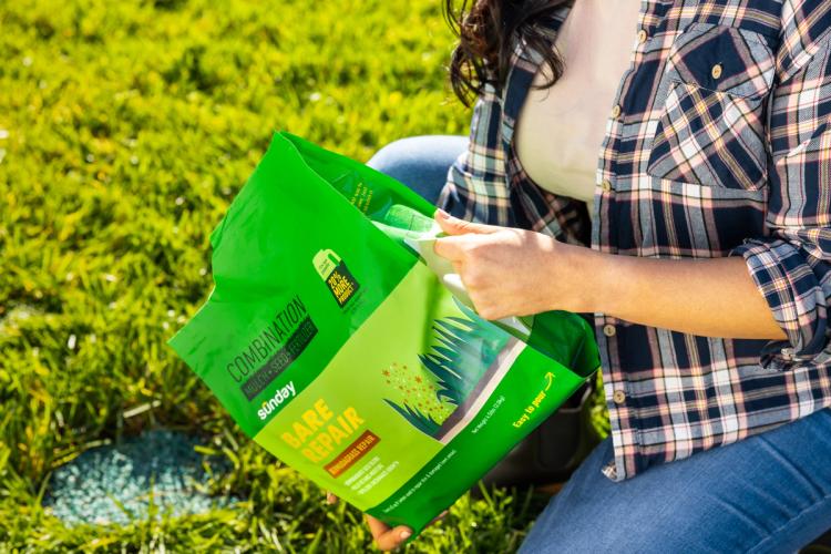 Woman pouring Bare Repair using bag handle