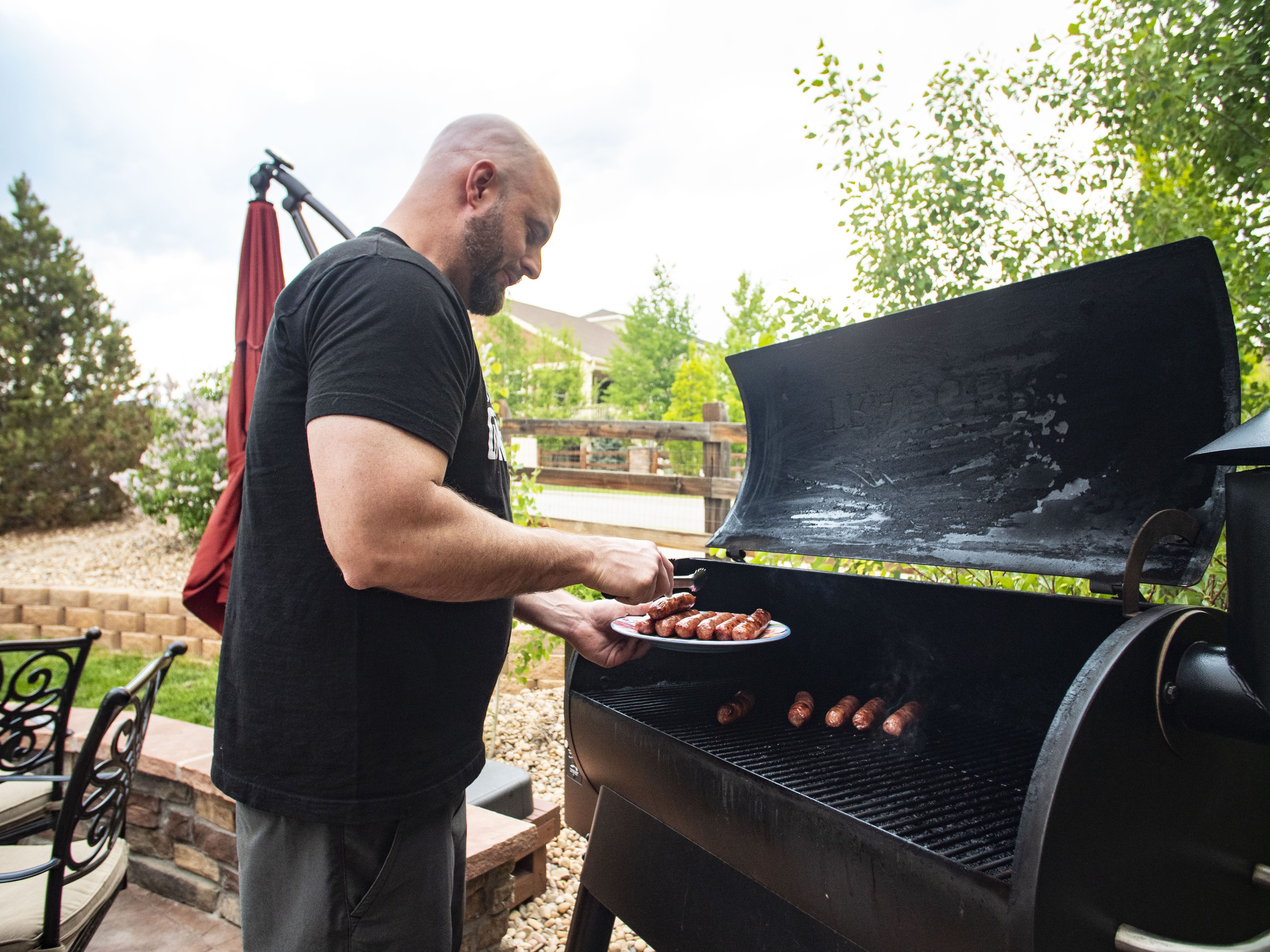 Man grilling bratwursts