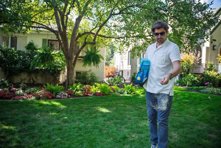 Image of a man seeding his lawn