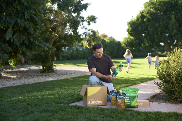 Man unboxing his Custom Yard Plan