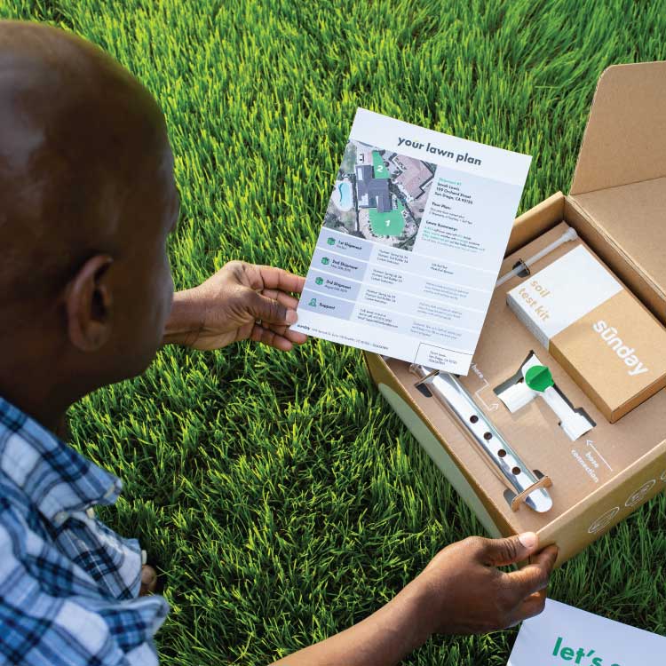 Man opening a Sunday lawn care subscription