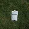 Green Out liquid lawn fertilizer pouch on lawn