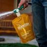 Man applying Sunday Drought Defense lawn treatment on lawn