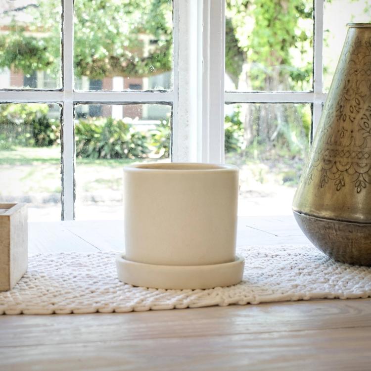 Lifestyle image of cream Hyde pot on a windowsill