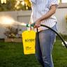 A woman sprays Sunday Lawn Kickstart