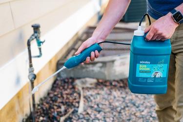 Person applying barrier perimeter application of Bug Doom.