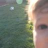 Close up of baby and soccer ball on a green Sunday lawn