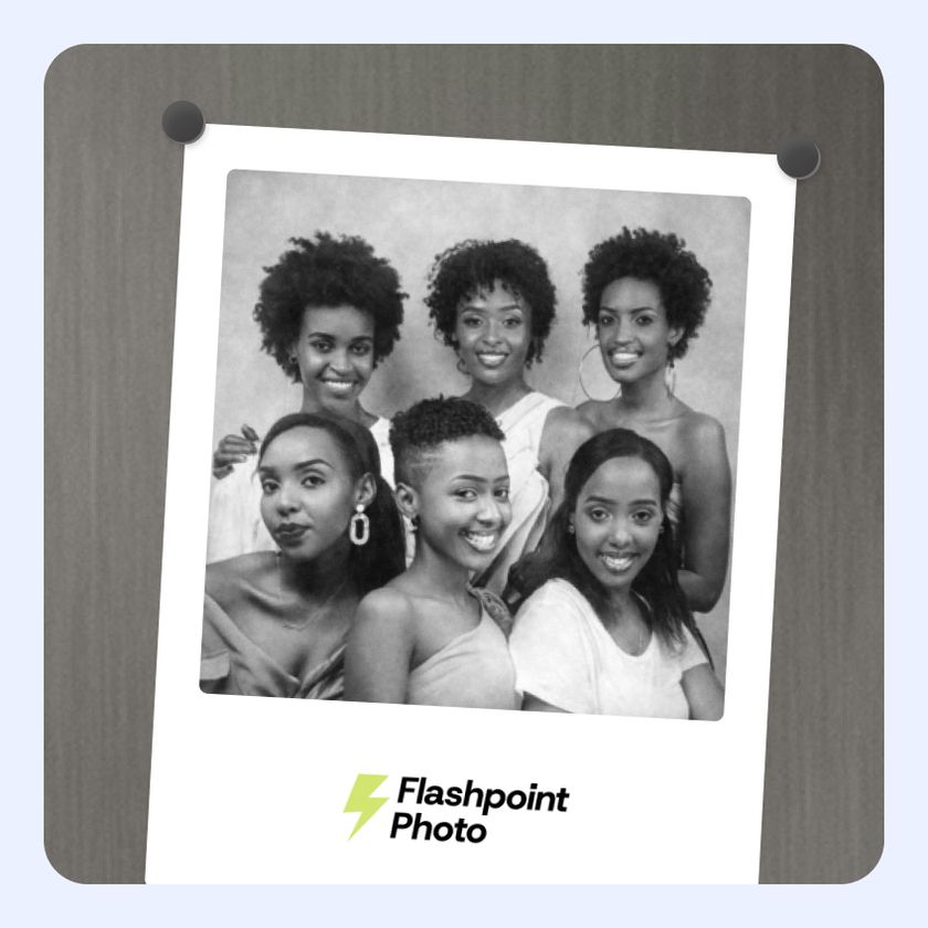 A woman holding an oversized photo booth print done at a wedding.  She is holding the print and is happy with it.  It was created with Booth.Events.