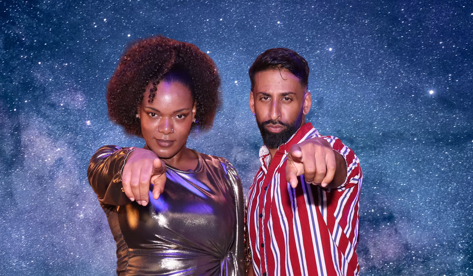 The same people using the photo booth, but now the background has been replaced with stars.
