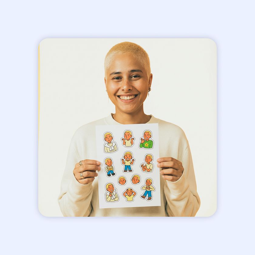 A happy photo booth guest holds up a sheet of stickers cut with Booth.Events.