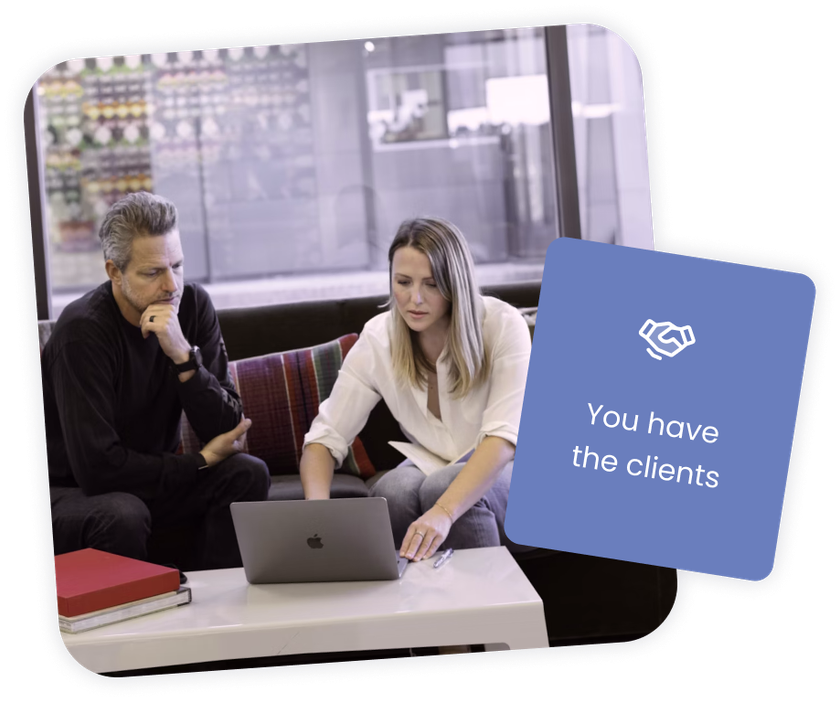 Two people are sitting down discussing an event. The photographer is convincing the client to upgrade and add a photo booth.