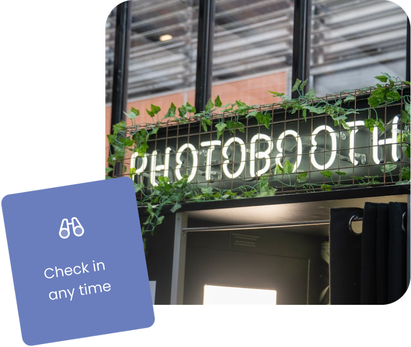 This image shows a glowing neon sign for an installed photo booth with a label saying "Check in any time". Booth.Events is easy to manage with Live-Sync.
