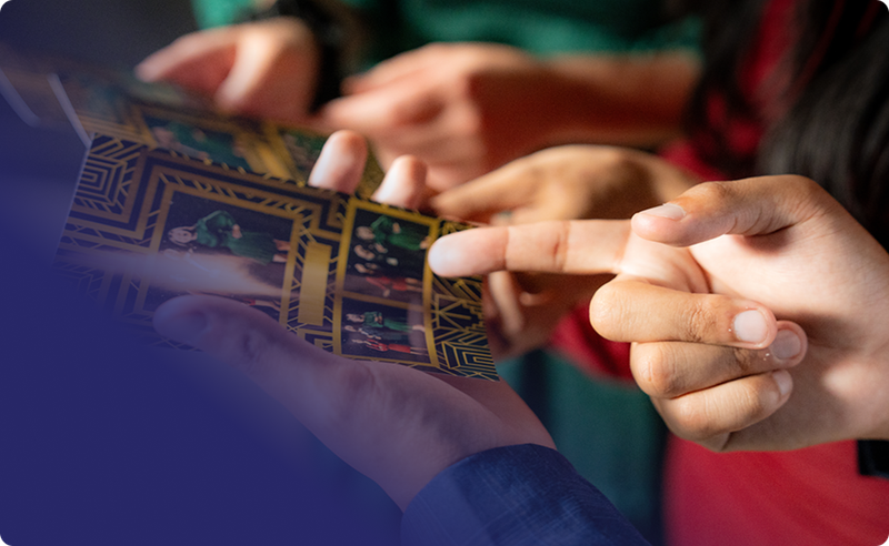 Printed outputs from a Booth.Events capture in the hands of guests.  The guests are comparing their results and pointing at them.