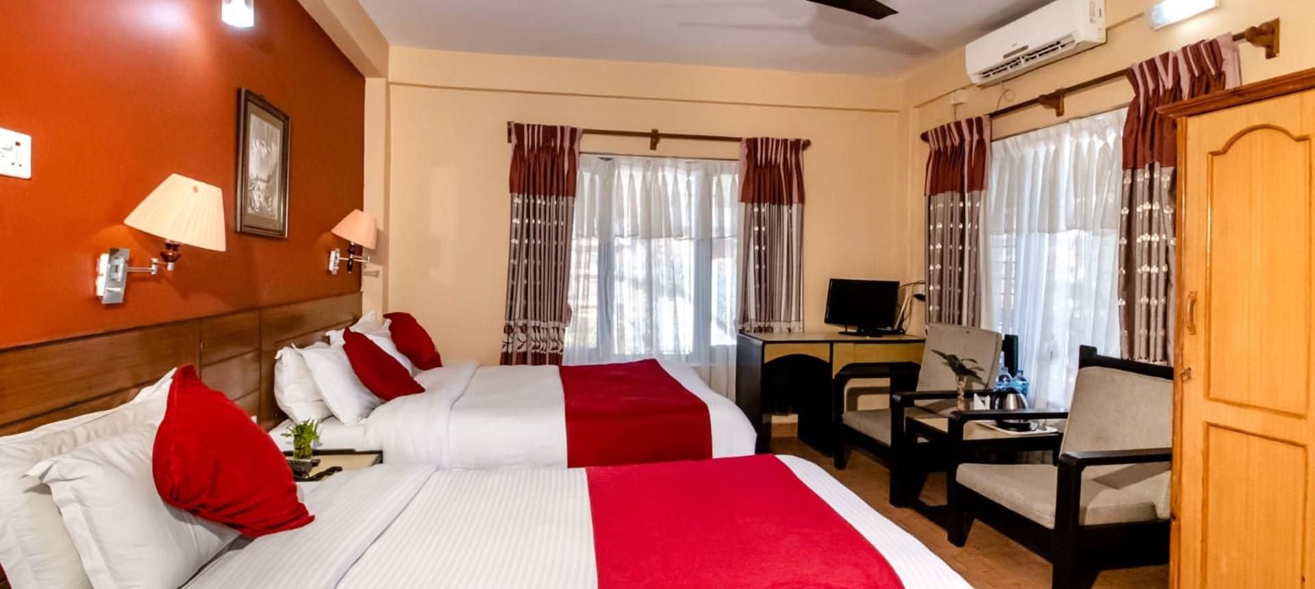 A guest room with a double bed and a sitting area