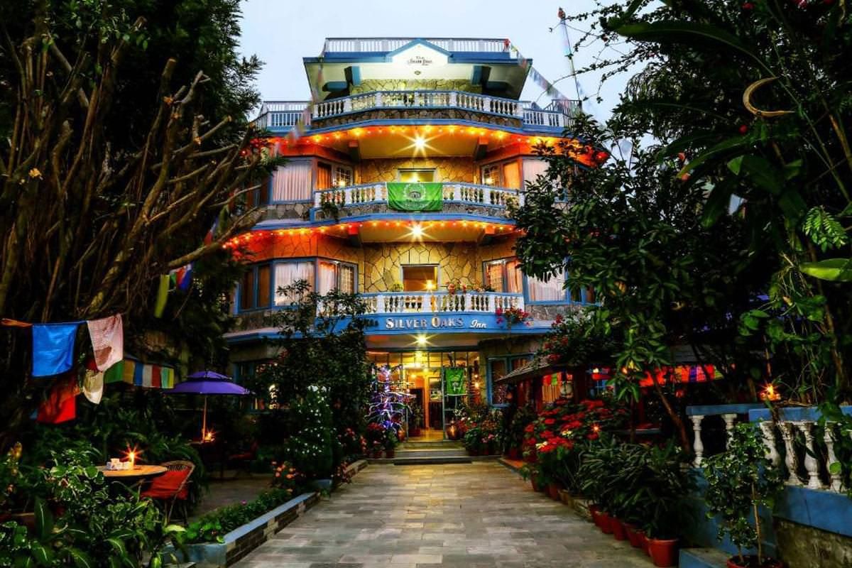 Silver Oaks Inn at dusk, seen along the garden path
