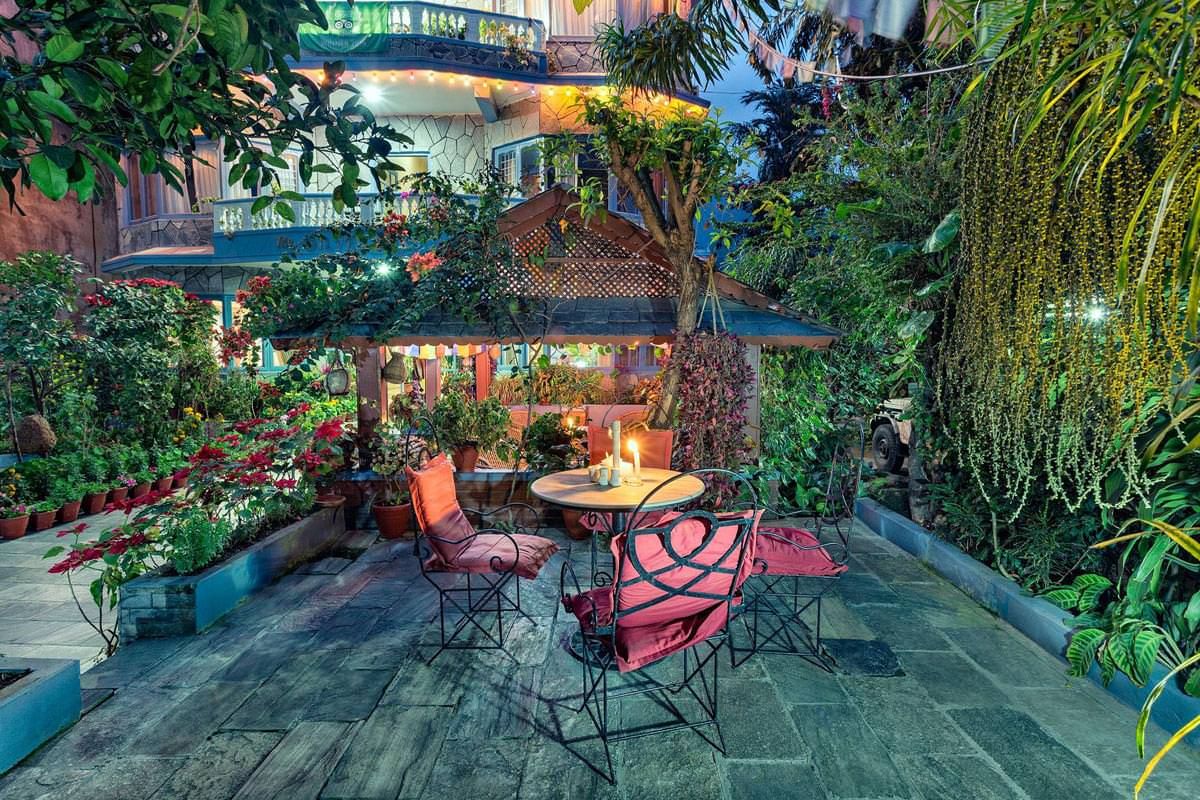 Tables on the garden terrace among the plants