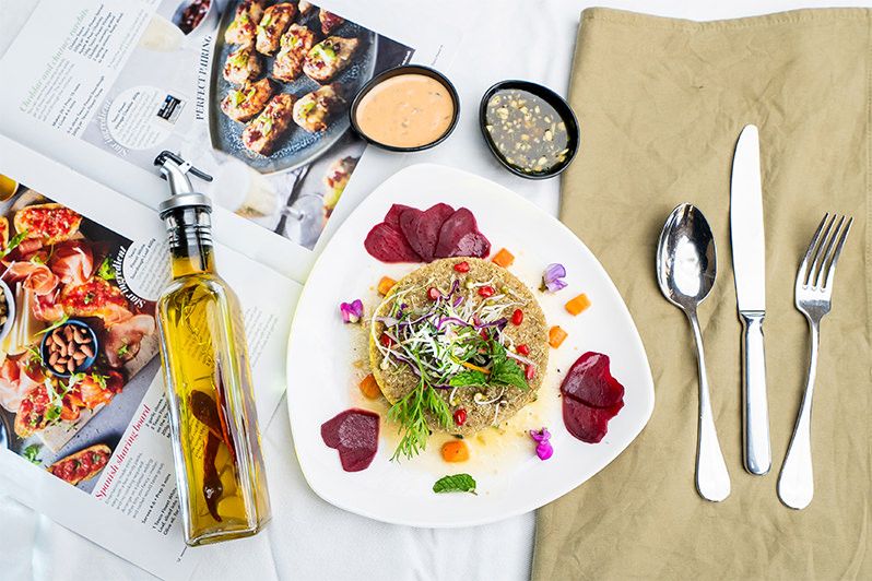A plated salad of fresh greens and beetroot