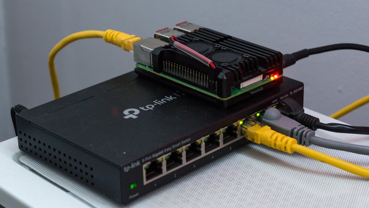 A Raspberry Pi 4 single-board computer resting on a network switch.