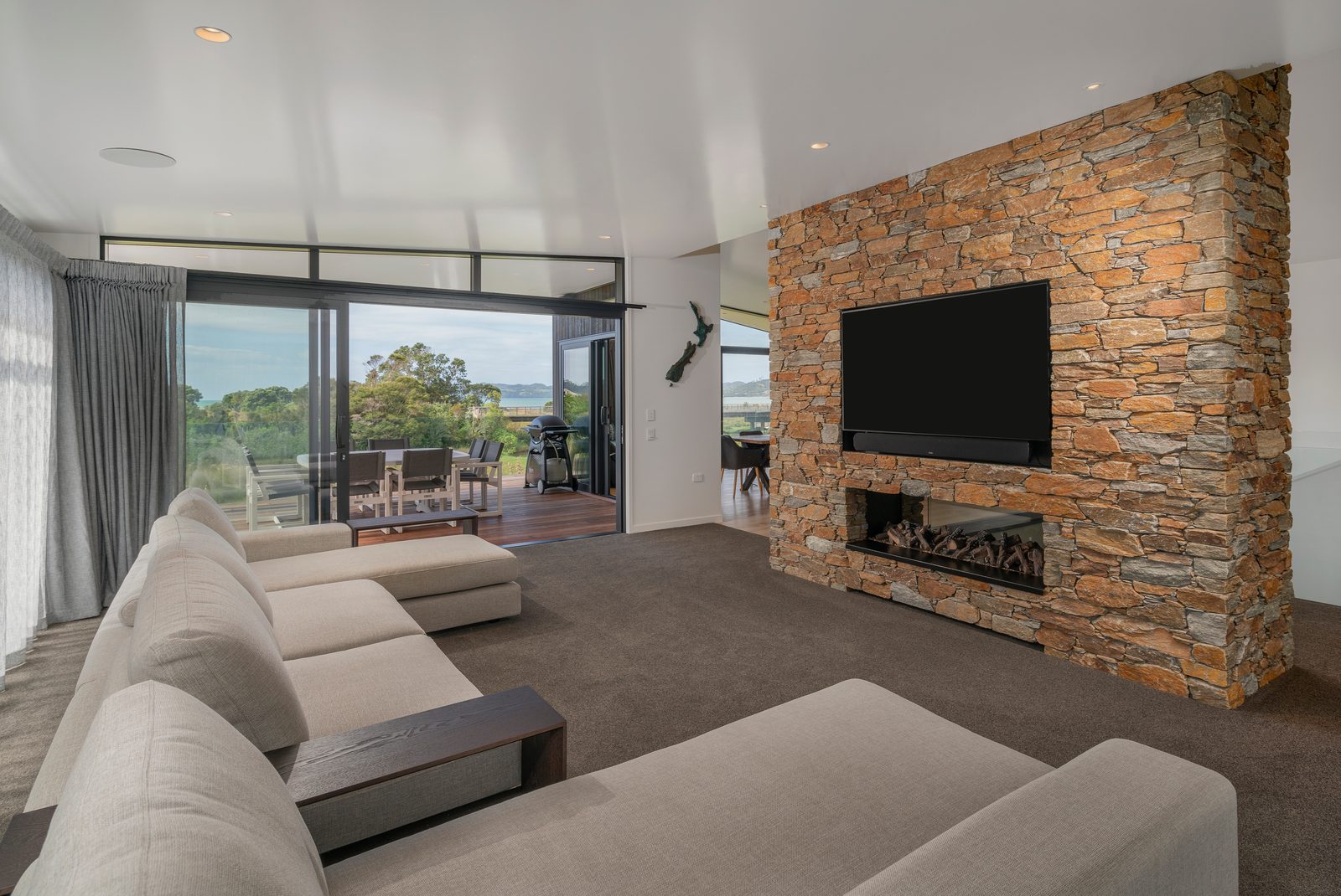 Cook Drive, Whitianga — lounge and fireplace