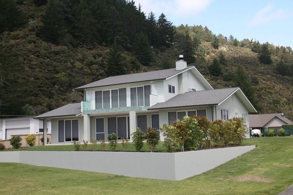 Matarangi — the home against the bush-clad hill