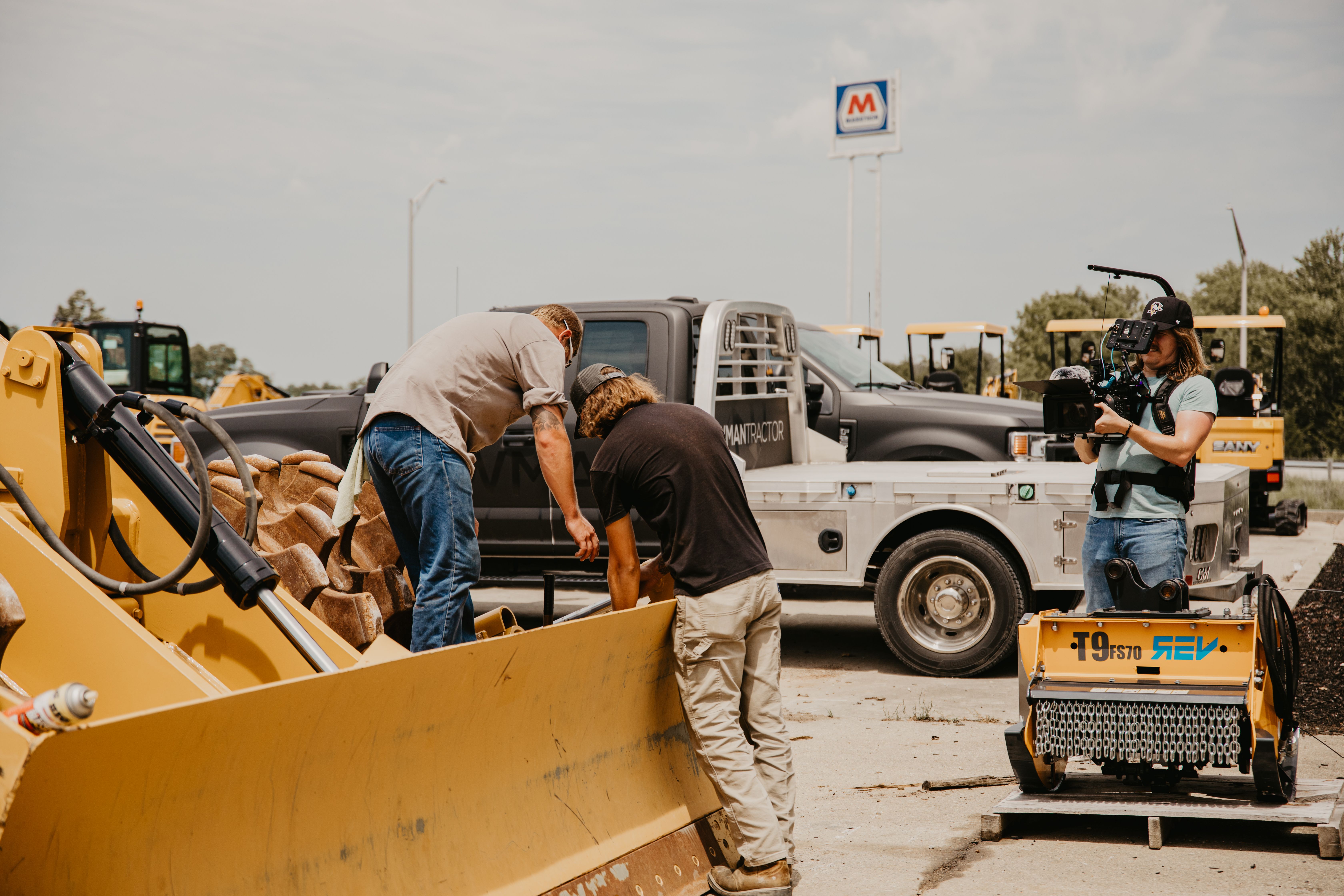 Two techs working on heavy machinery