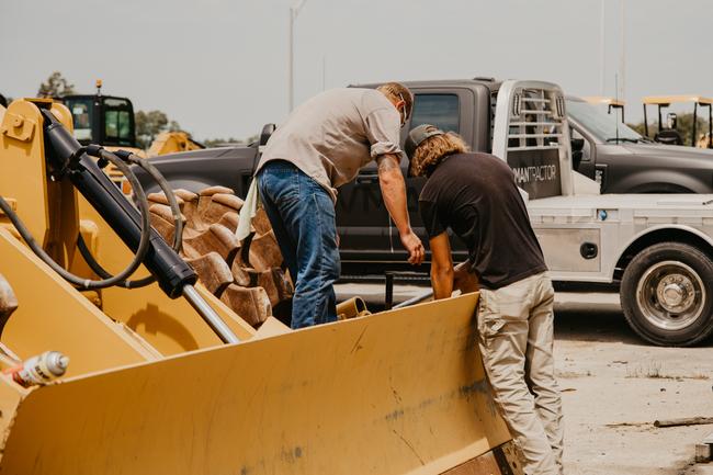 Two techs working on heavy machinery