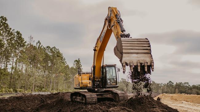 SANY SY335C excavator bucket digging into a field