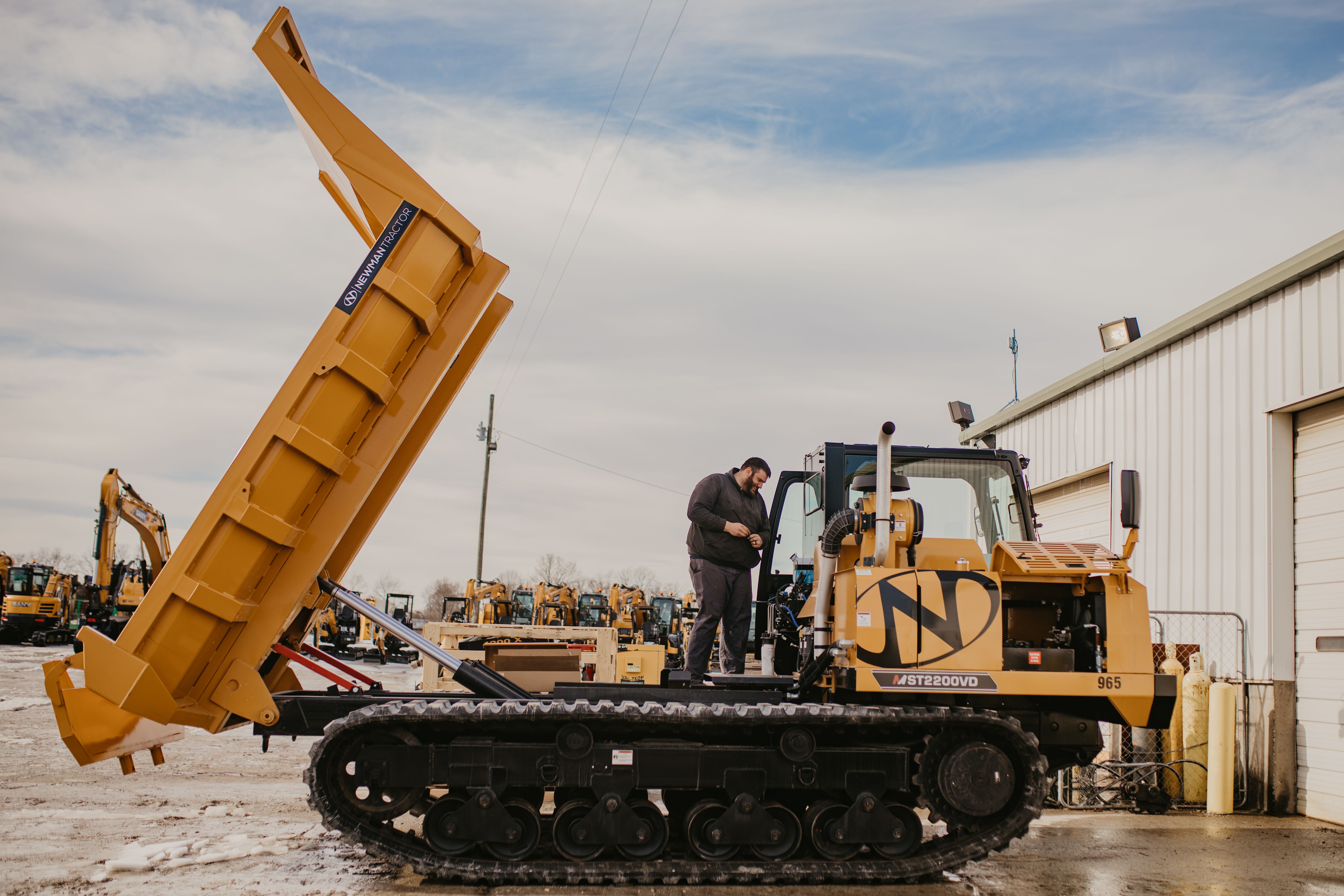 heavy-equipment-technician-works-on-morooka-tracked-dump-truck