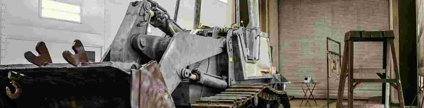 heavy equipment repair man drilling