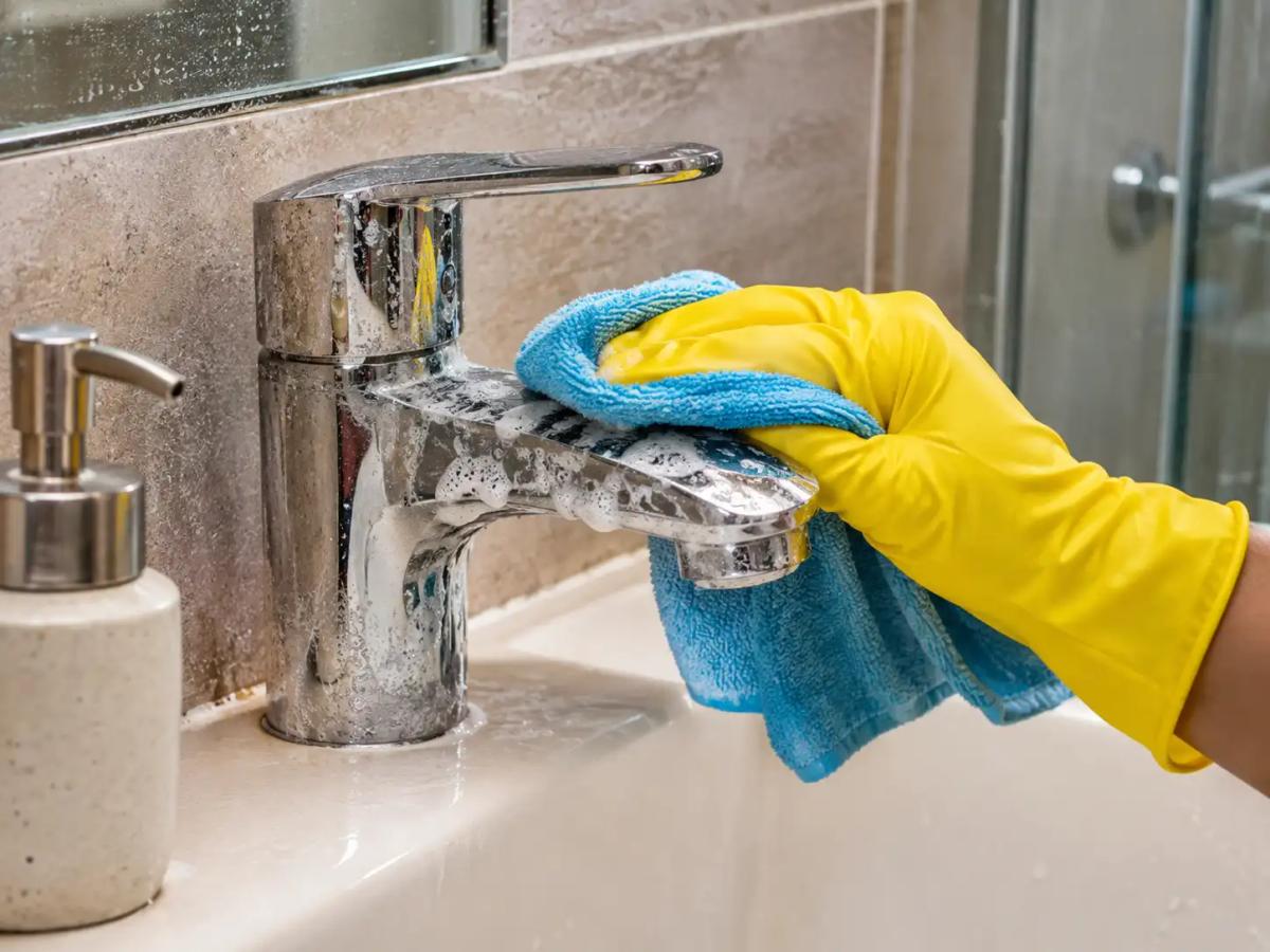 Removing hard water limescale stains from a bathroom chrome tap