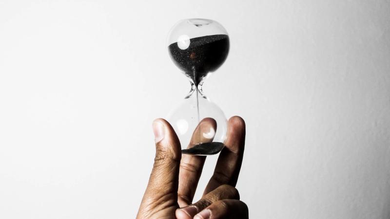person holding hour glass