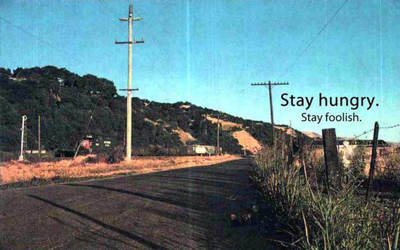 a stretch of highway with the quote "stay hungry stay foolish"