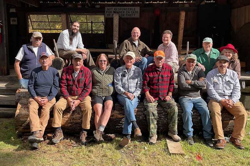 Volunteers posing by 1920s Saw Mill
