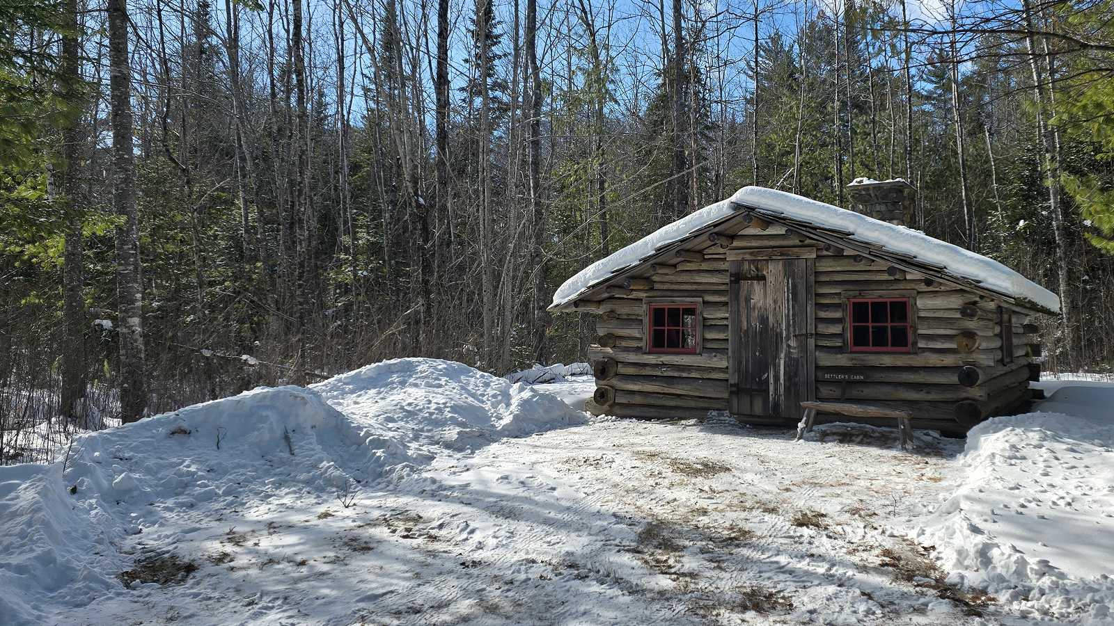 Exterior, snow covered view of the Settlers cabin 