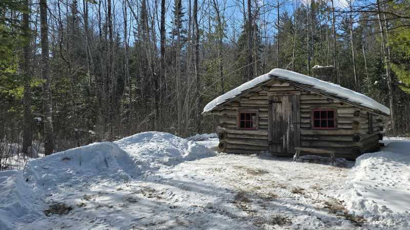 Exterior, snow covered view of the Settlers cabin 