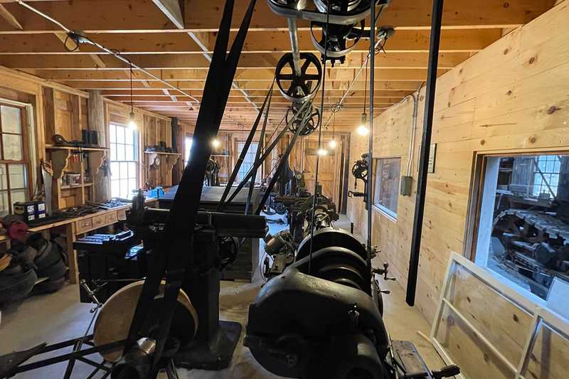 Lineshaft, pulleys and leather belts powering all of the equipment in the machine shop 