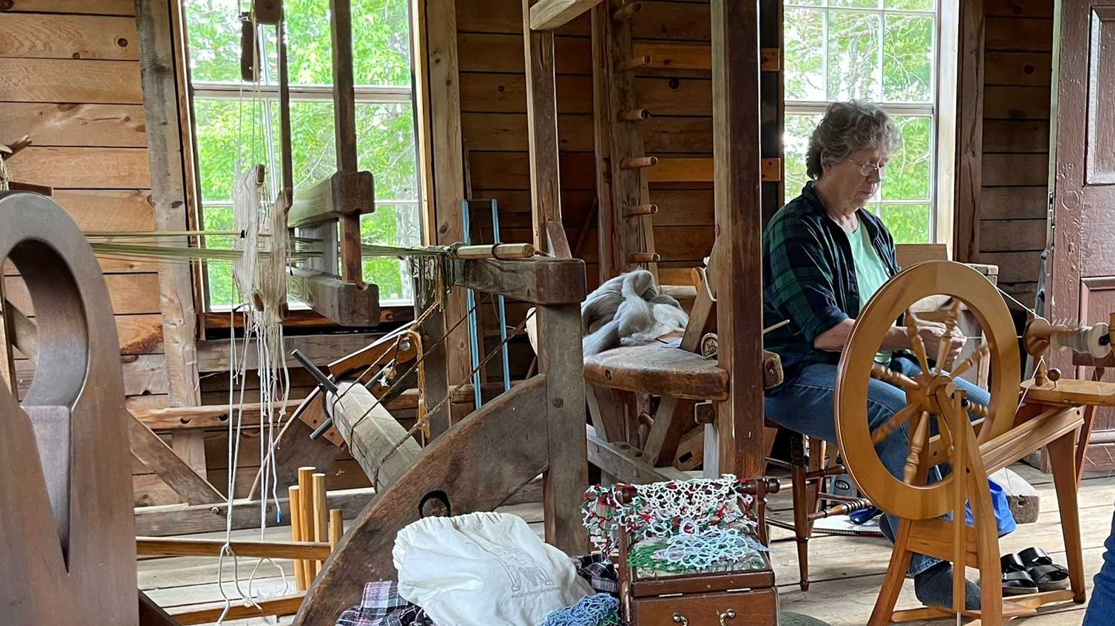 Volunteer spinning wool during museum event