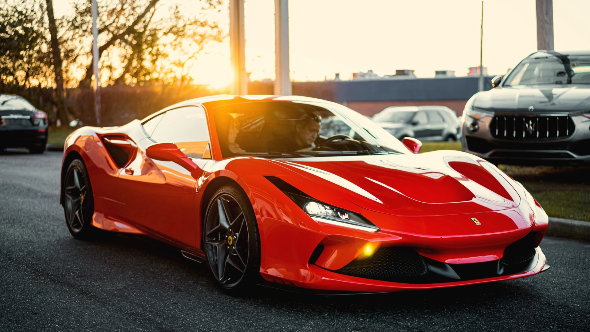 Glossy red finish panel of a sports car close-up with light reflection