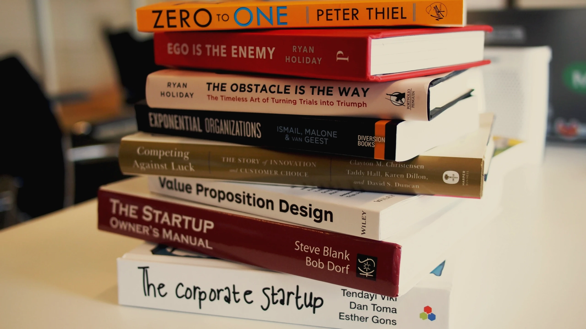 Open artistic book showing editorial layouts on desk surface