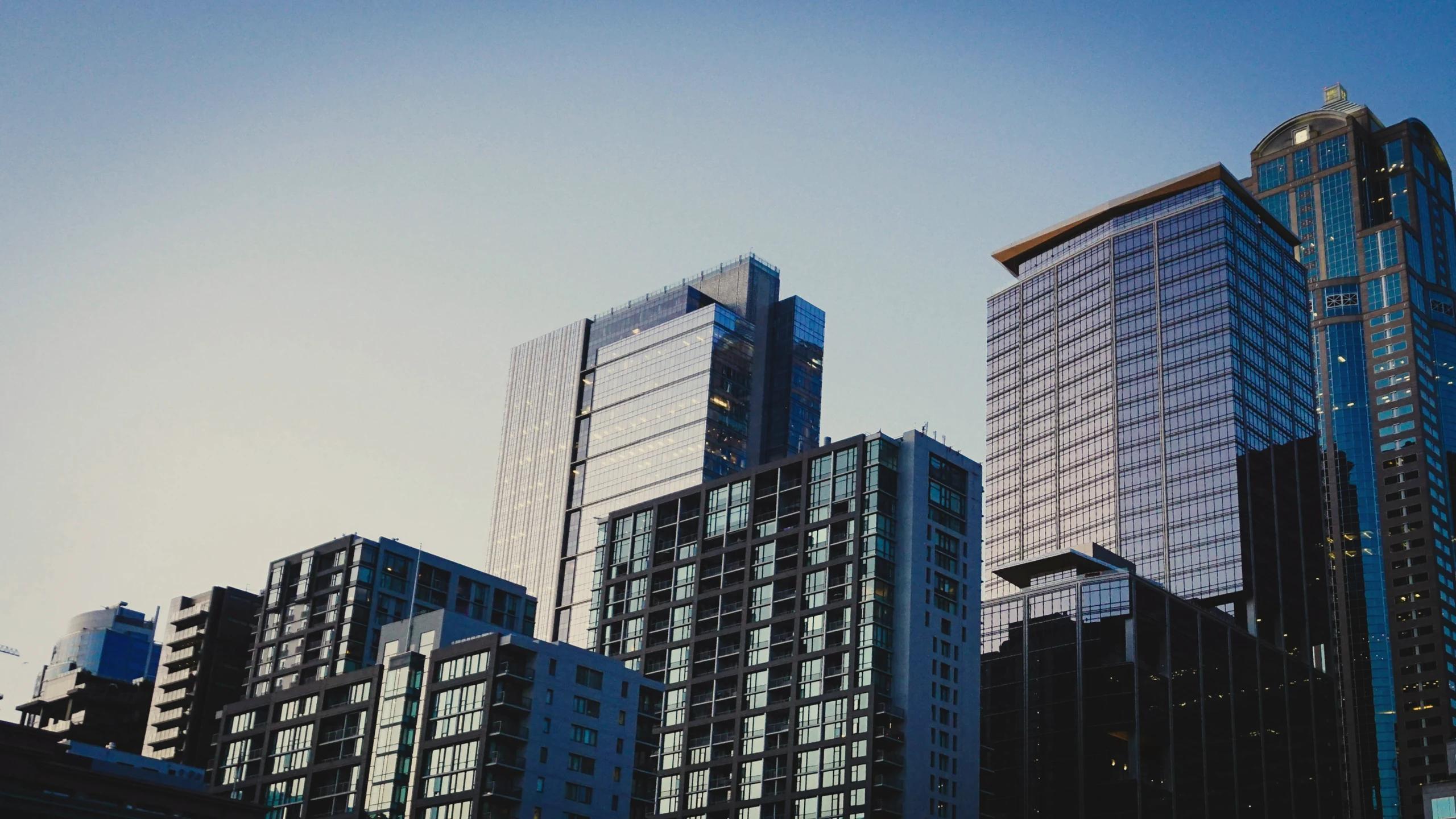 High-angle perspective of dense city buildings under clear sky